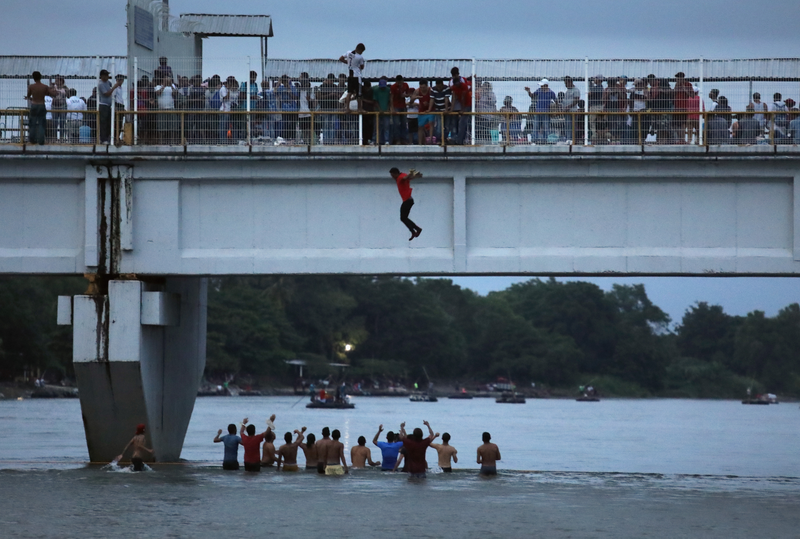 People are jumping into the river below to enter Mexico from Guatemala October 20, 2018.